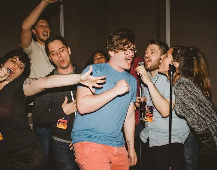 People singing karaoke at React Conf