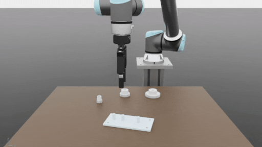 GIF showing robot arm picking up and placing gears.