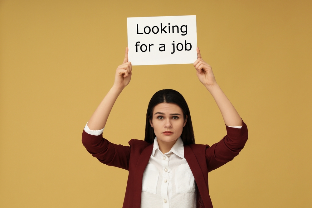 Unemployment,problem.,unhappy,woman,holding,sign,with,phrase,looking,for