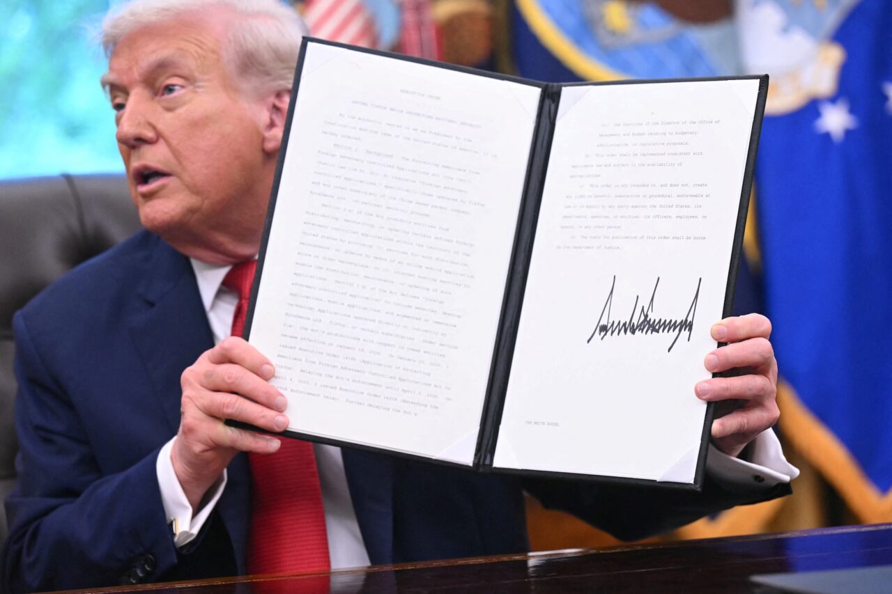 President Donald Trump shows an executive order about Tiktok he signed in the Oval Office of the White House in Washington, DC, on September 25, 2025.