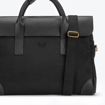 black bag with leather accents and a shoulder strap black bag with leather accents and a shoulder strap