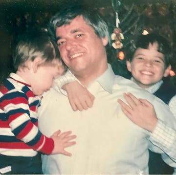 a person holding a couple of boys a person holding a couple of boys