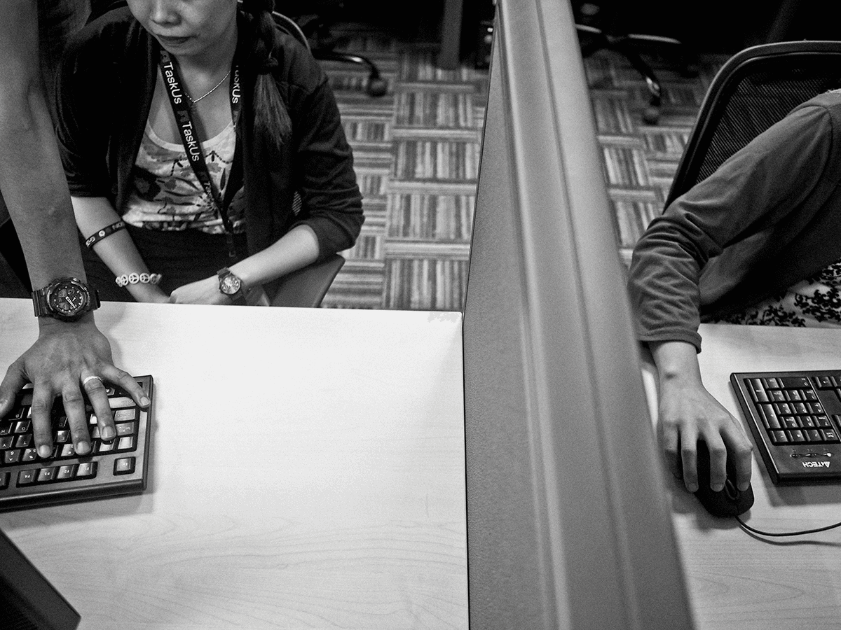Photograph of people working in an office with keyboards