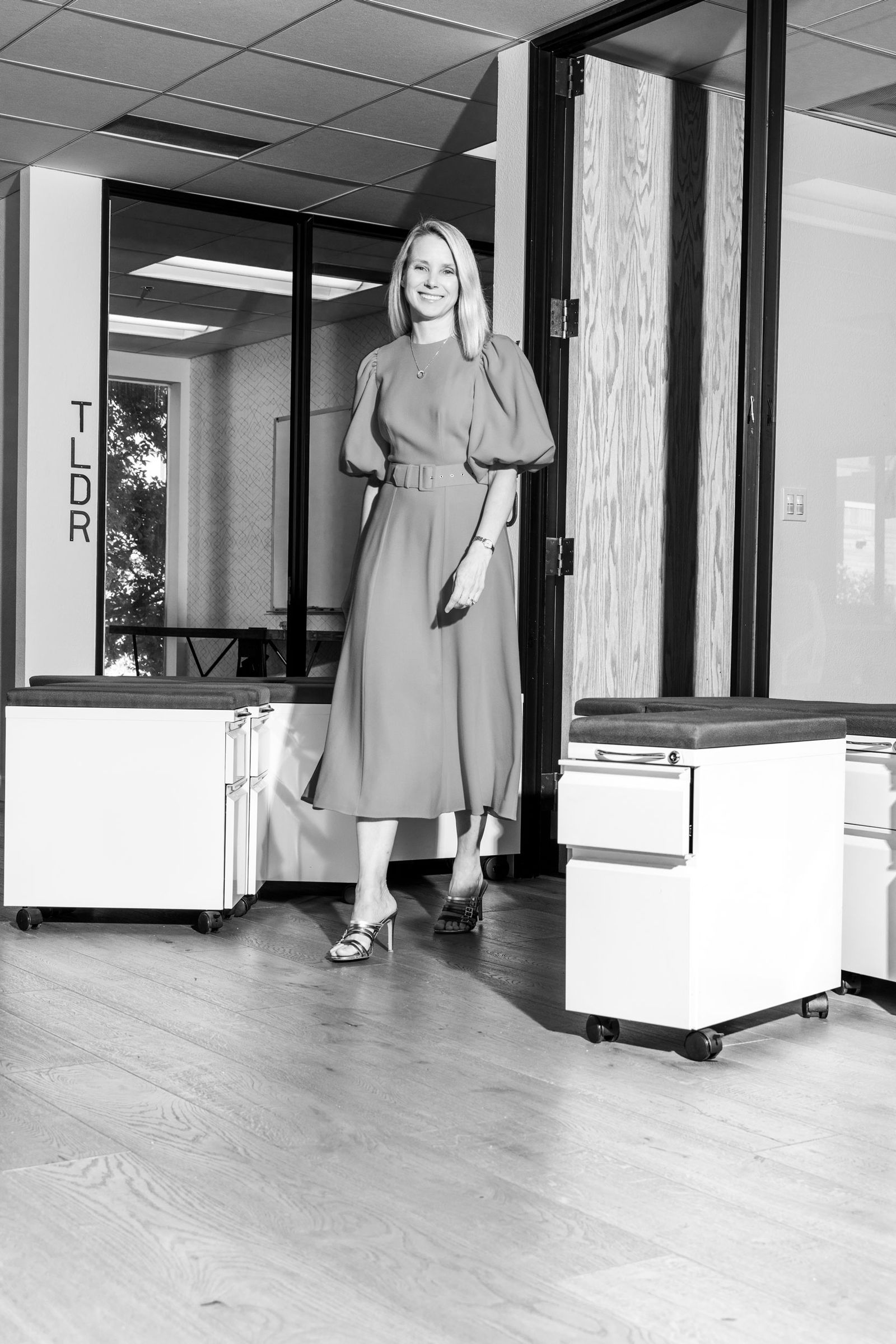 Image may contain Marissa Mayer Floor Flooring Adult Person Clothing Dress Furniture Indoors Table Skirt and Face