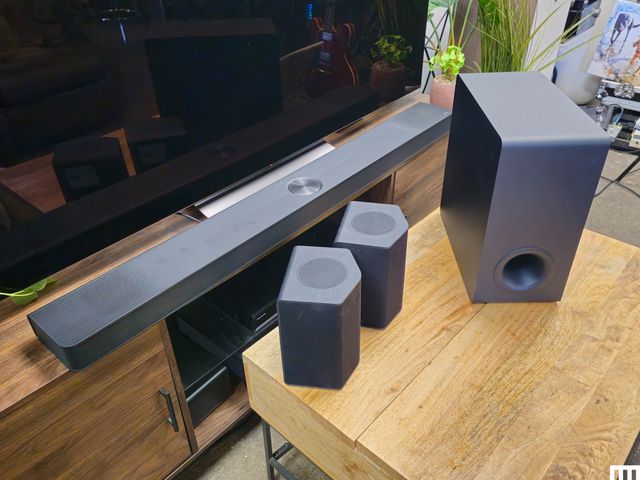 Side view of L.G. S95TR speaker system including long flat speaker 2 angular speakers and one rectangular speaker