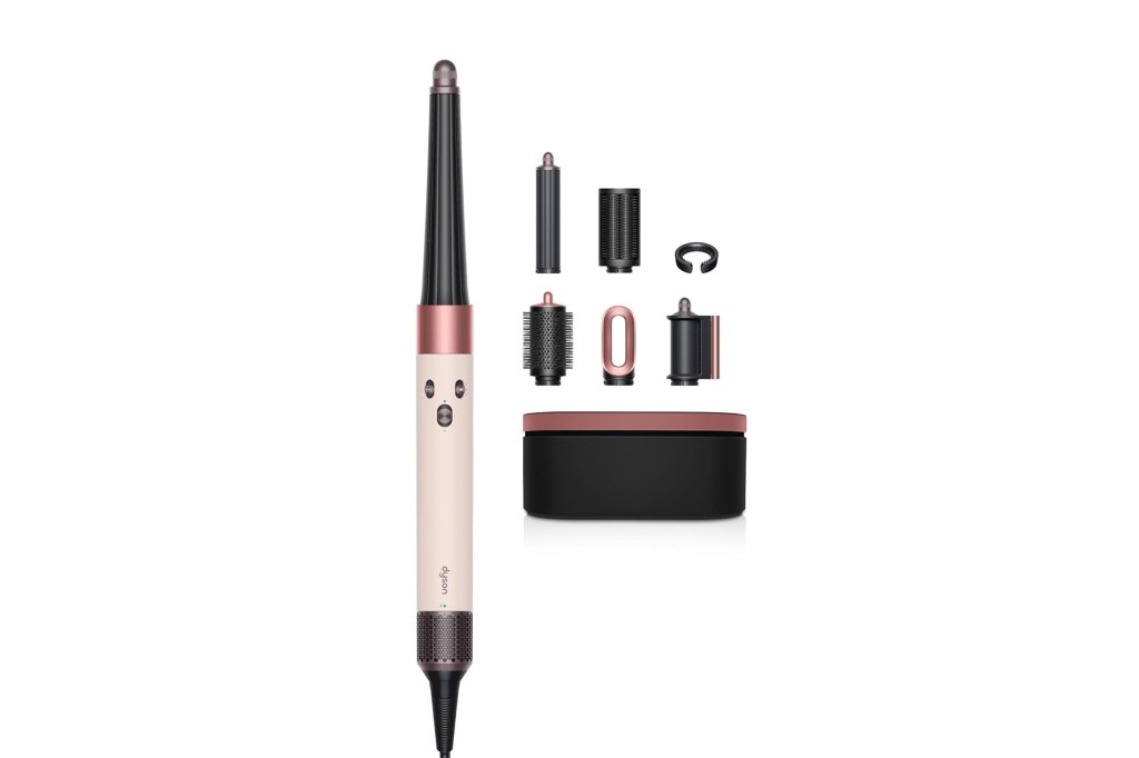 Dyson Airwrap styler in pink and black with multiple attachments and a storage case.