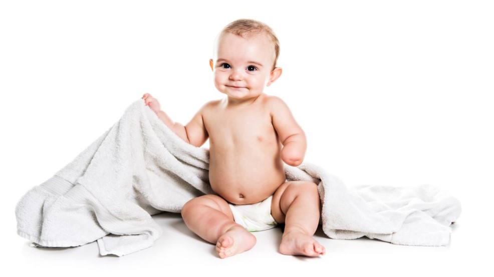 BDbaby.jpg Un bebé contento al que le falta una mano debido a una deficiencia congénita en las extremidades, sentado sobre una manta.