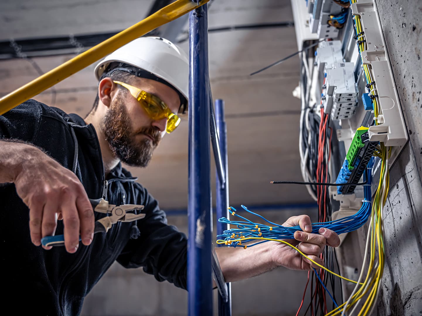 A commercial electrician working with wires