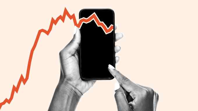Montage image of a chart line and a phone in someone’s hand