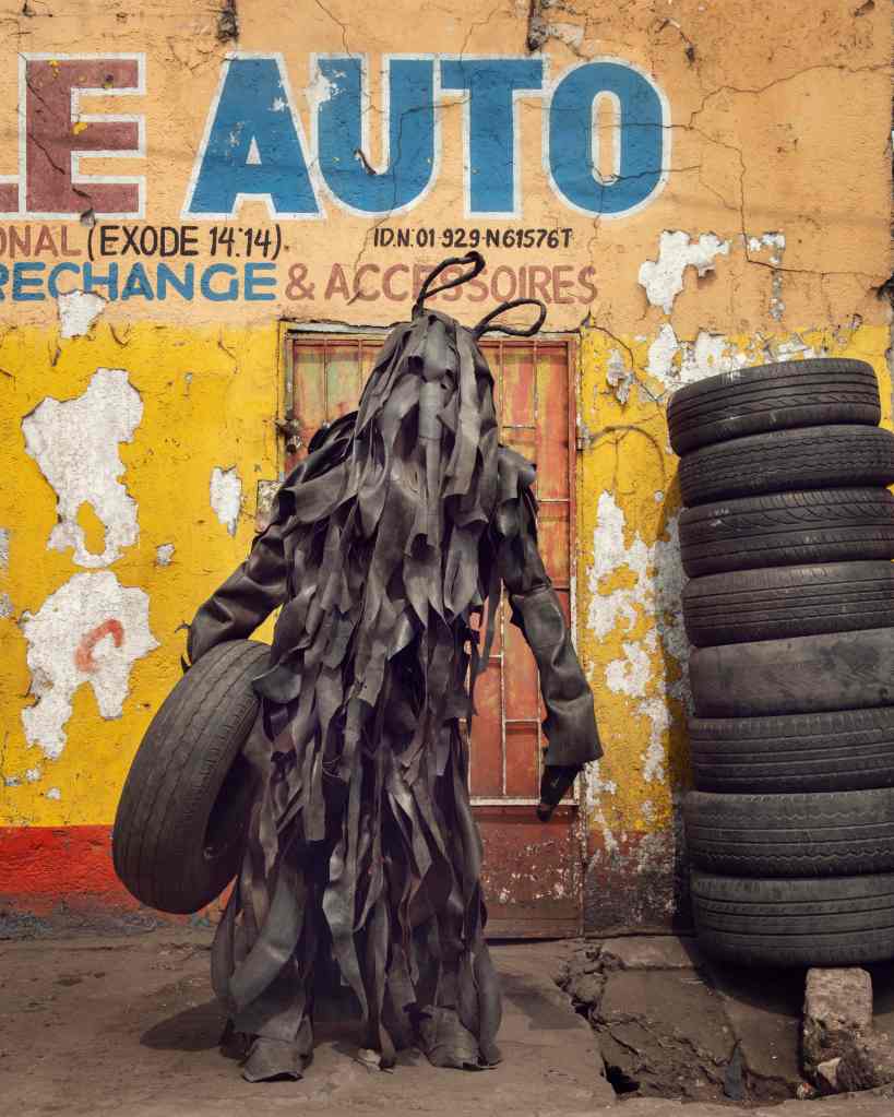 A person wearing a costume made of old car tyres